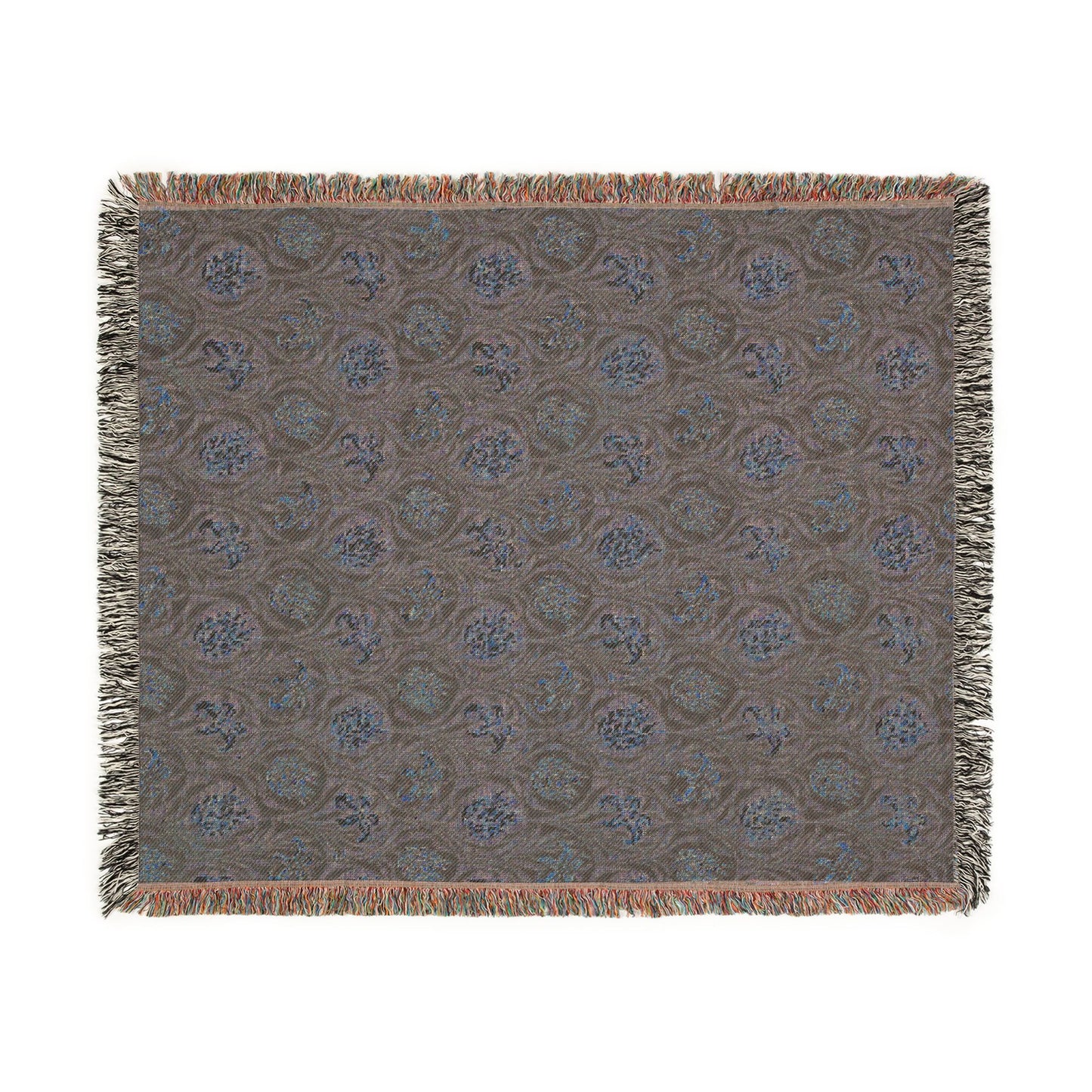 Patterned throw blanket with fringe on a white background