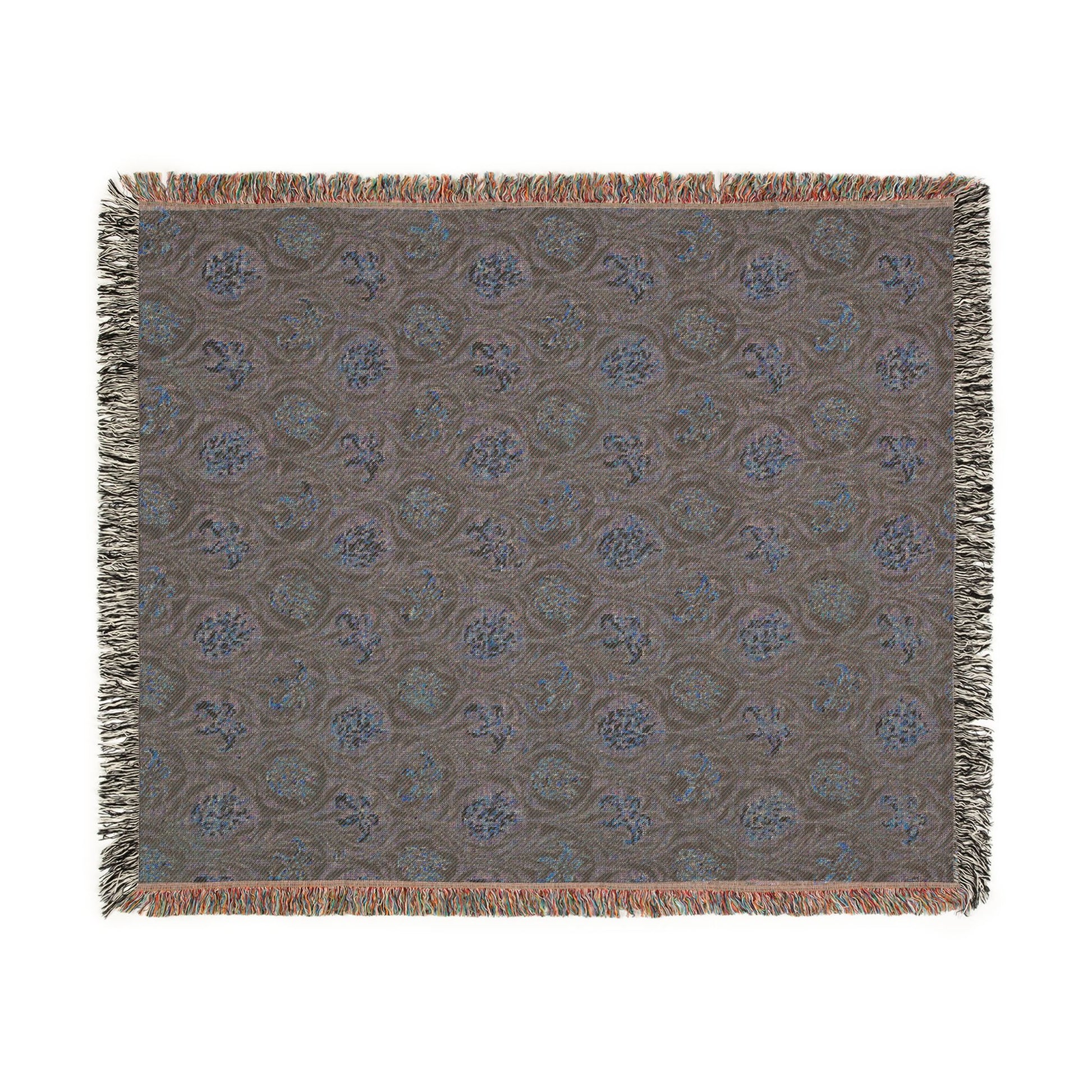 Patterned throw blanket with fringe on a white background
