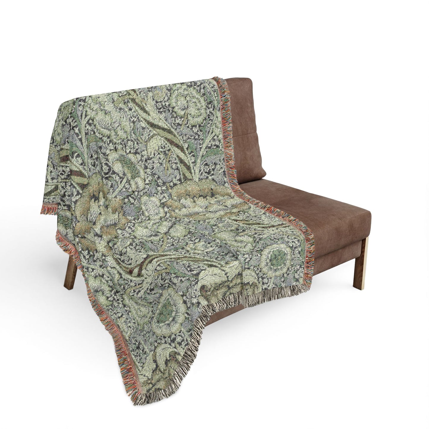 Floral patterned throw blanket draped over a brown chair on a white background
