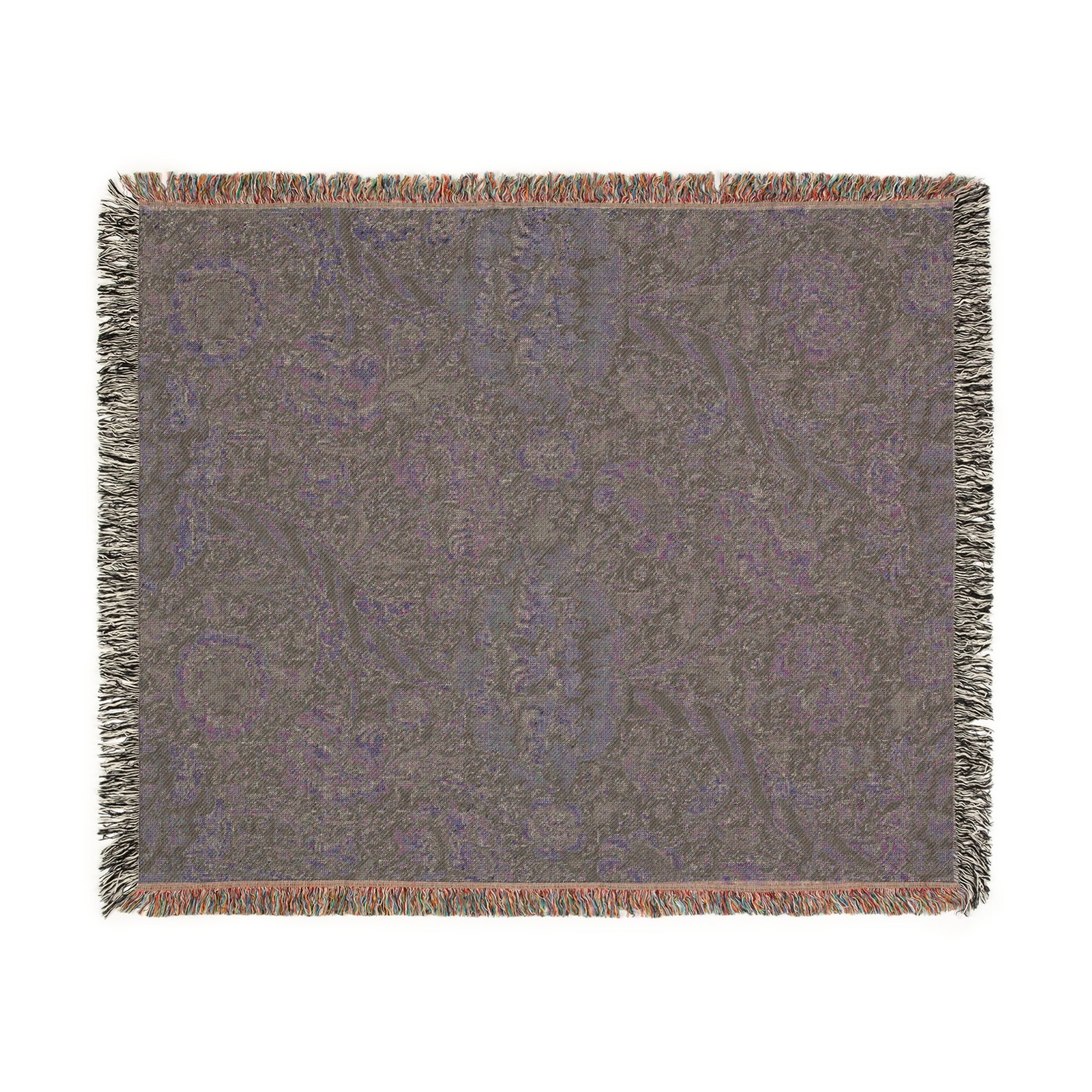 A woven cotton blanket with a geometric William Morris & Co pattern in shades of gray and a colourful fringe along the edges.