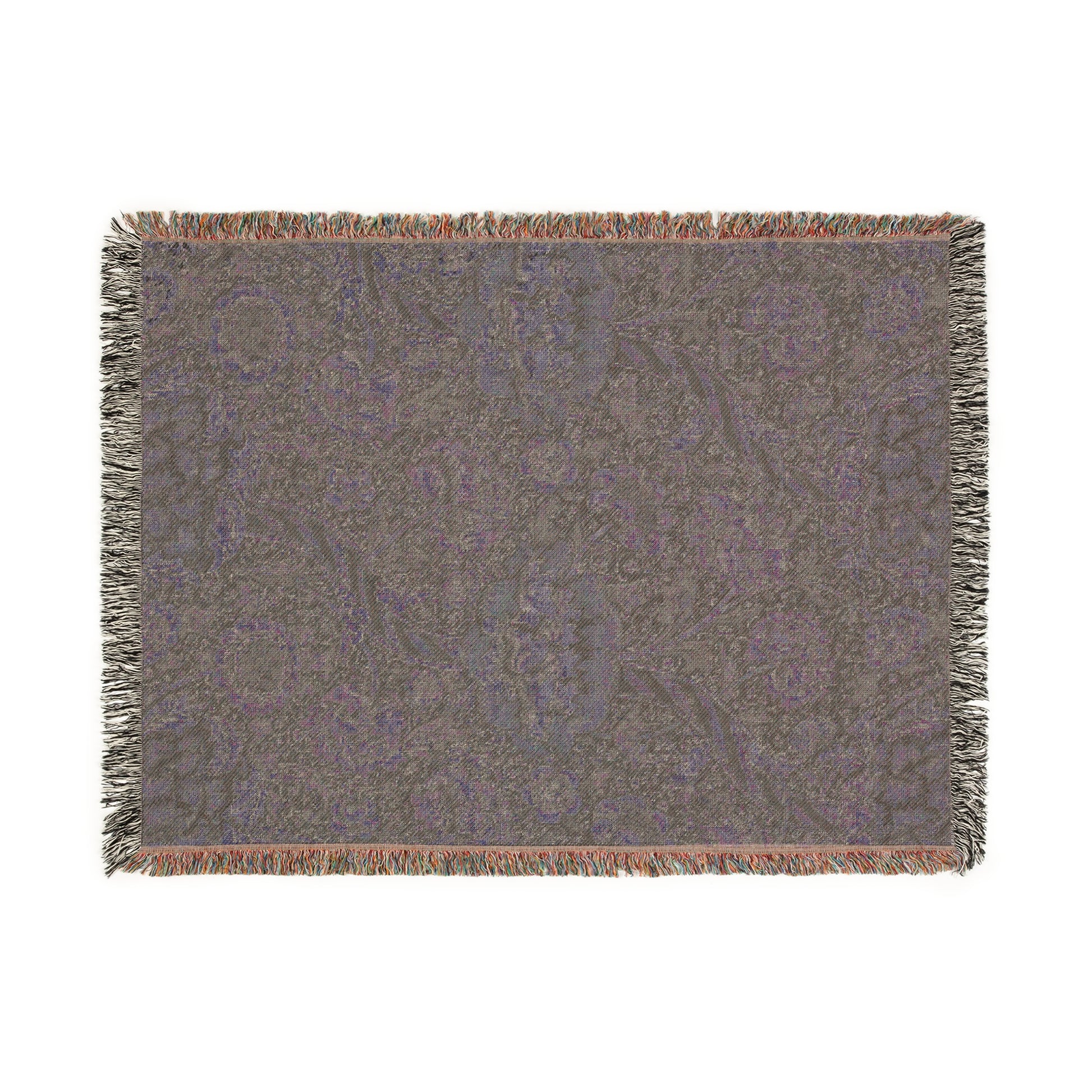 A woven cotton blanket with a geometric William Morris & Co pattern in shades of gray and a colourful fringe along the edges.