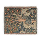 A woven cotton blanket with a floral and bird pattern, featuring a colorful fringe.