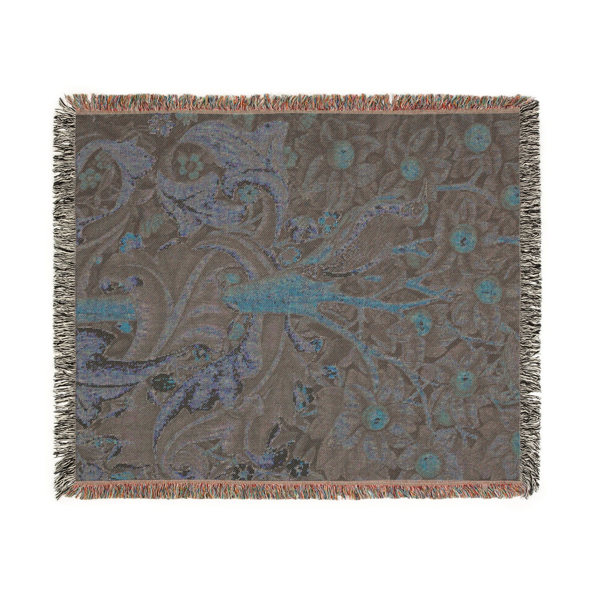 A woven cotton blanket with a William Morris & Co floral and bird pattern, featuring a colourful fringe.