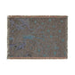 Decorative throw blanket with floral pattern on a plain background