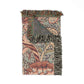 Decorative throw blanket with floral pattern and fringes on a white background