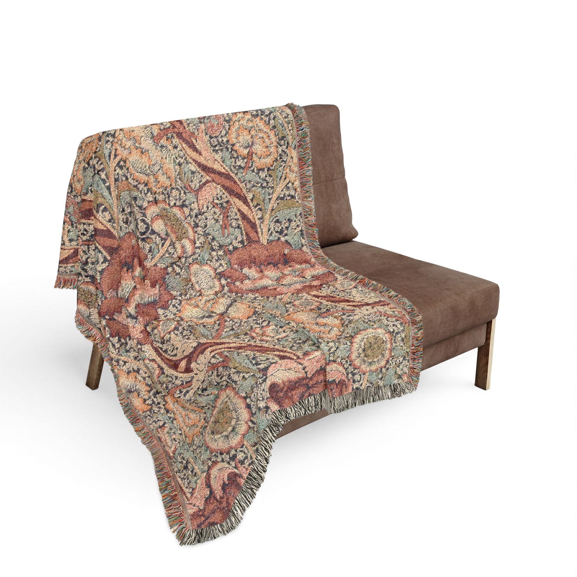 Floral patterned throw blanket draped over a brown chair on a white background