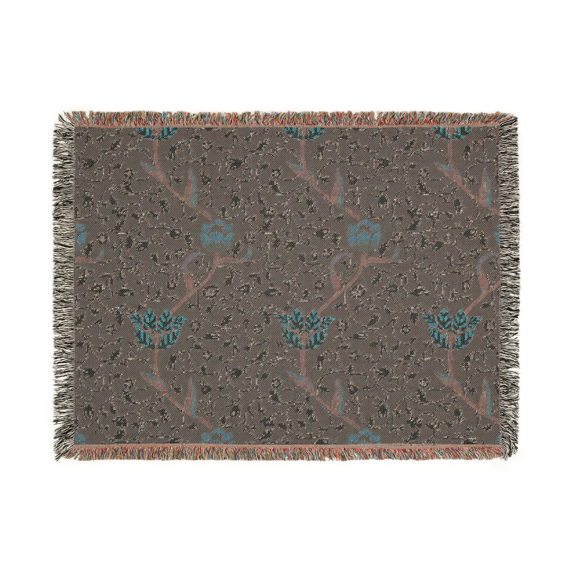 A woven cotton blanket with a geometric William Morris & Co pattern in blue, red and white colours, featuring fringed edges.