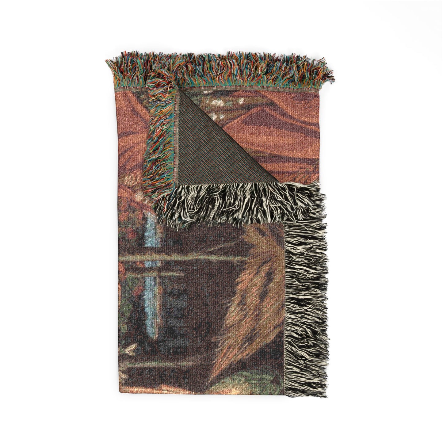 Woven blanket with fringes featuring a cabin design on a white background