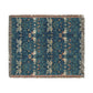 A woven cotton blanket with a geometric pattern in shades of blue and a fringed edge.