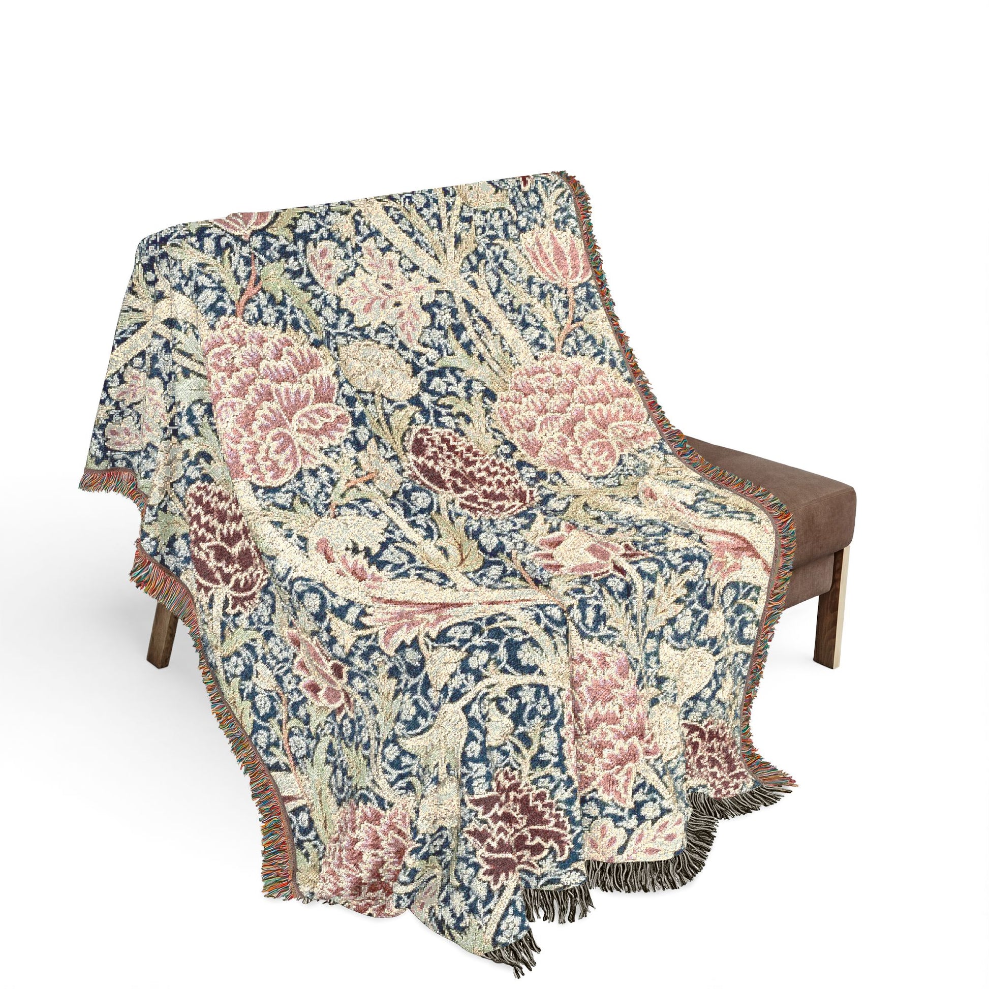 Floral patterned throw blanket draped over a chair on a white background