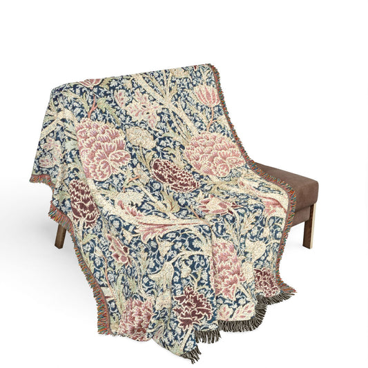 Floral patterned throw blanket draped over a chair on a white background