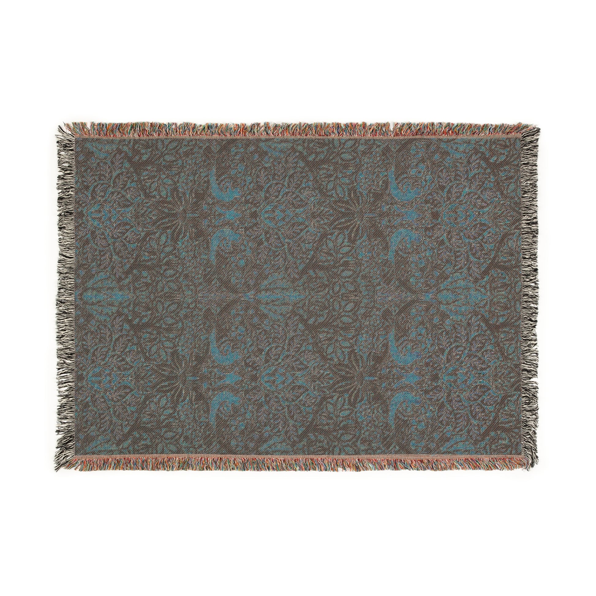 A woven cotton blanket with a floral William Morris & Co pattern in shades of brown, beige, and green, featuring colourful fringed edges.