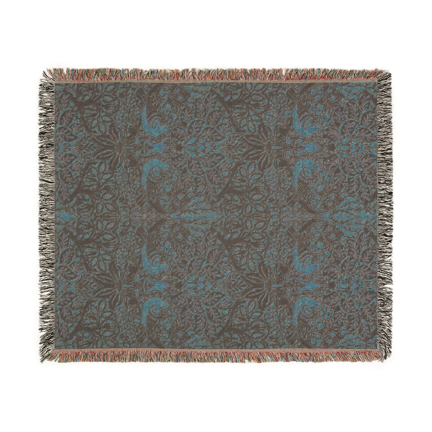 A woven cotton blanket with a floral William Morris & Co pattern in shades of brown, beige, and green, featuring colourful fringed edges.