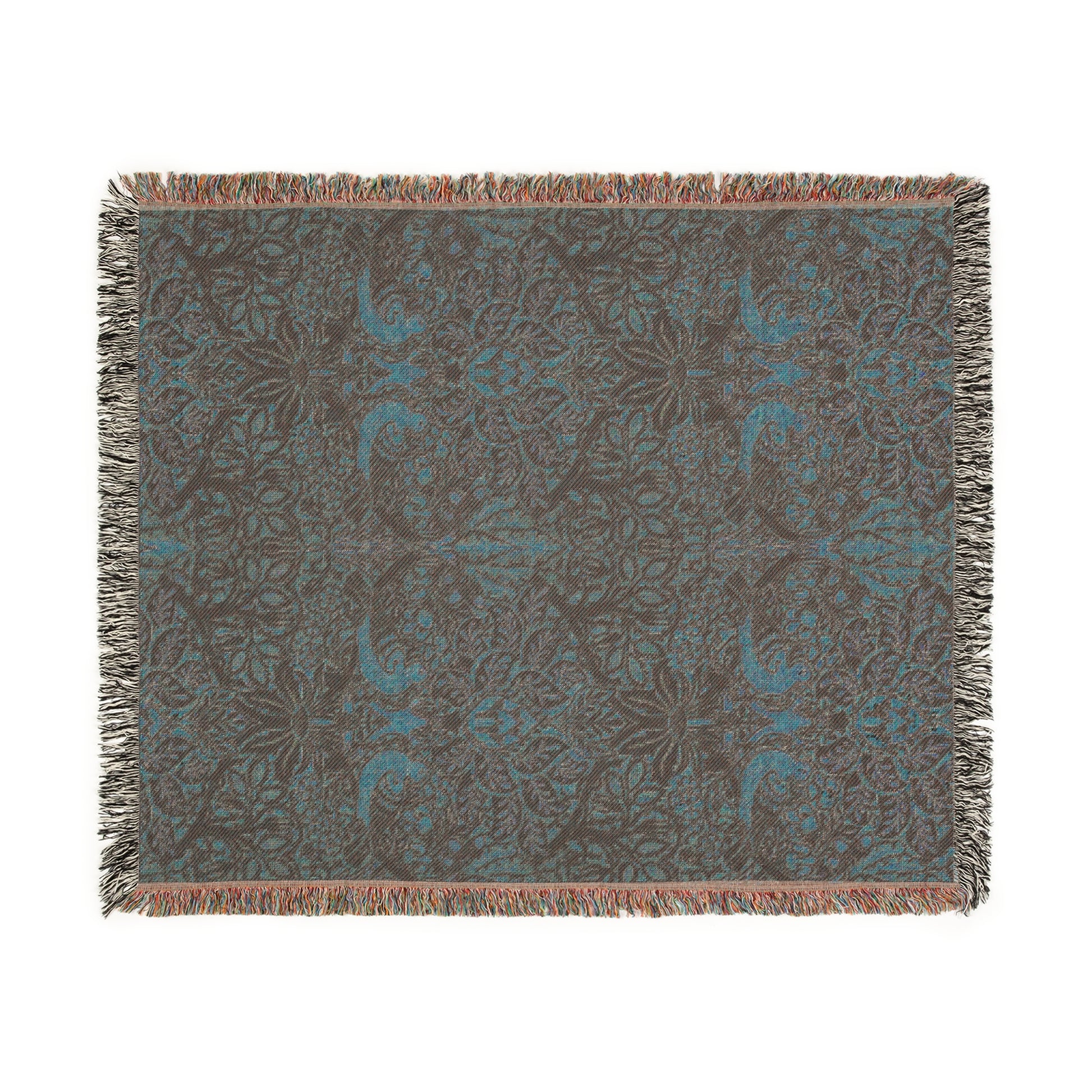 A woven cotton blanket with a floral William Morris & Co pattern in shades of brown, beige, and green, featuring colourful fringed edges.