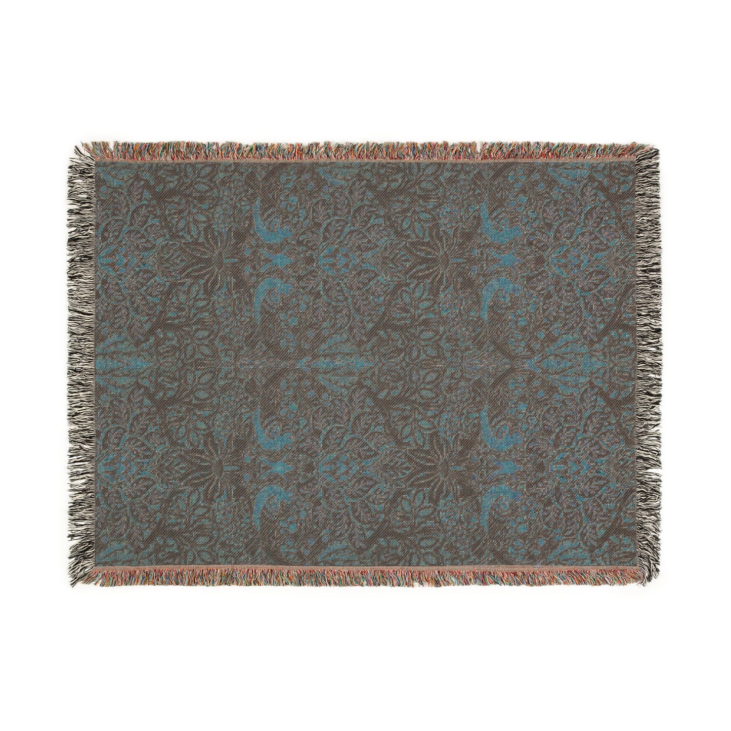 A woven cotton blanket with a floral William Morris & Co pattern in shades of brown, beige, and green, featuring colourful fringed edges.