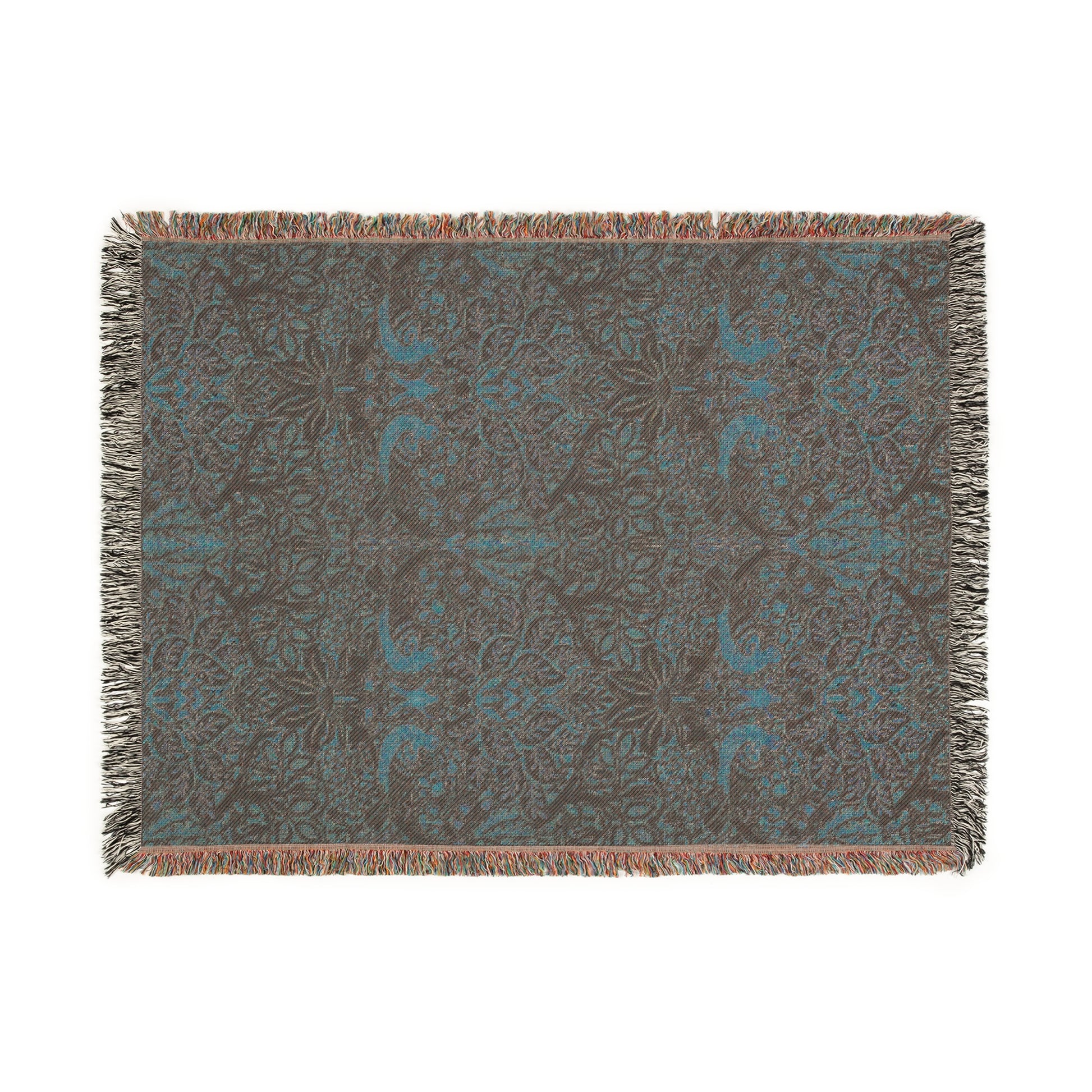 A woven cotton blanket with a floral William Morris & Co pattern in shades of brown, beige, and green, featuring colourful fringed edges.