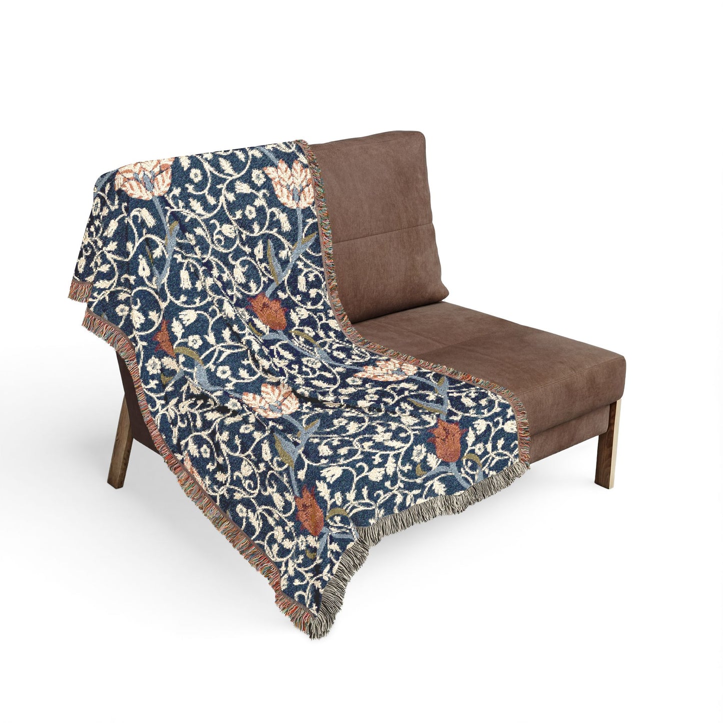 Decorative blanket with floral pattern draped over a brown chair on a white background