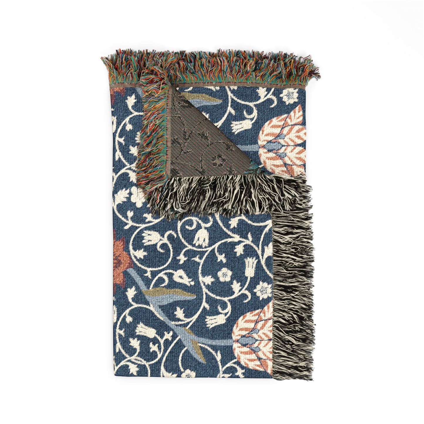 Decorative throw blanket with floral pattern and fringe on a white background