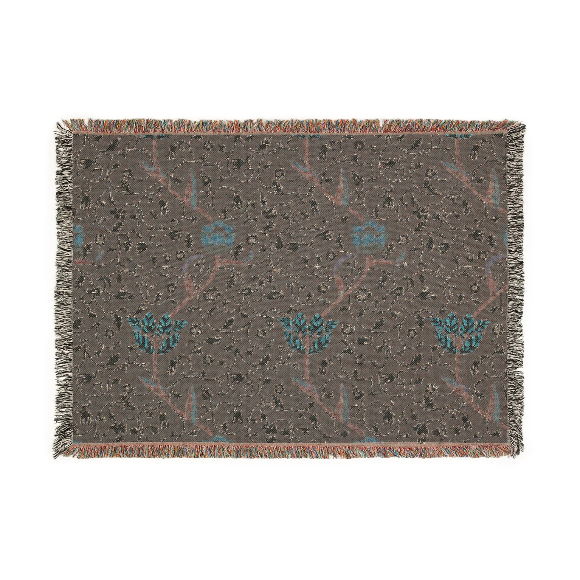 A woven cotton blanket with a geometric William Morris & Co pattern in blue, red and white colours, featuring fringed edges.