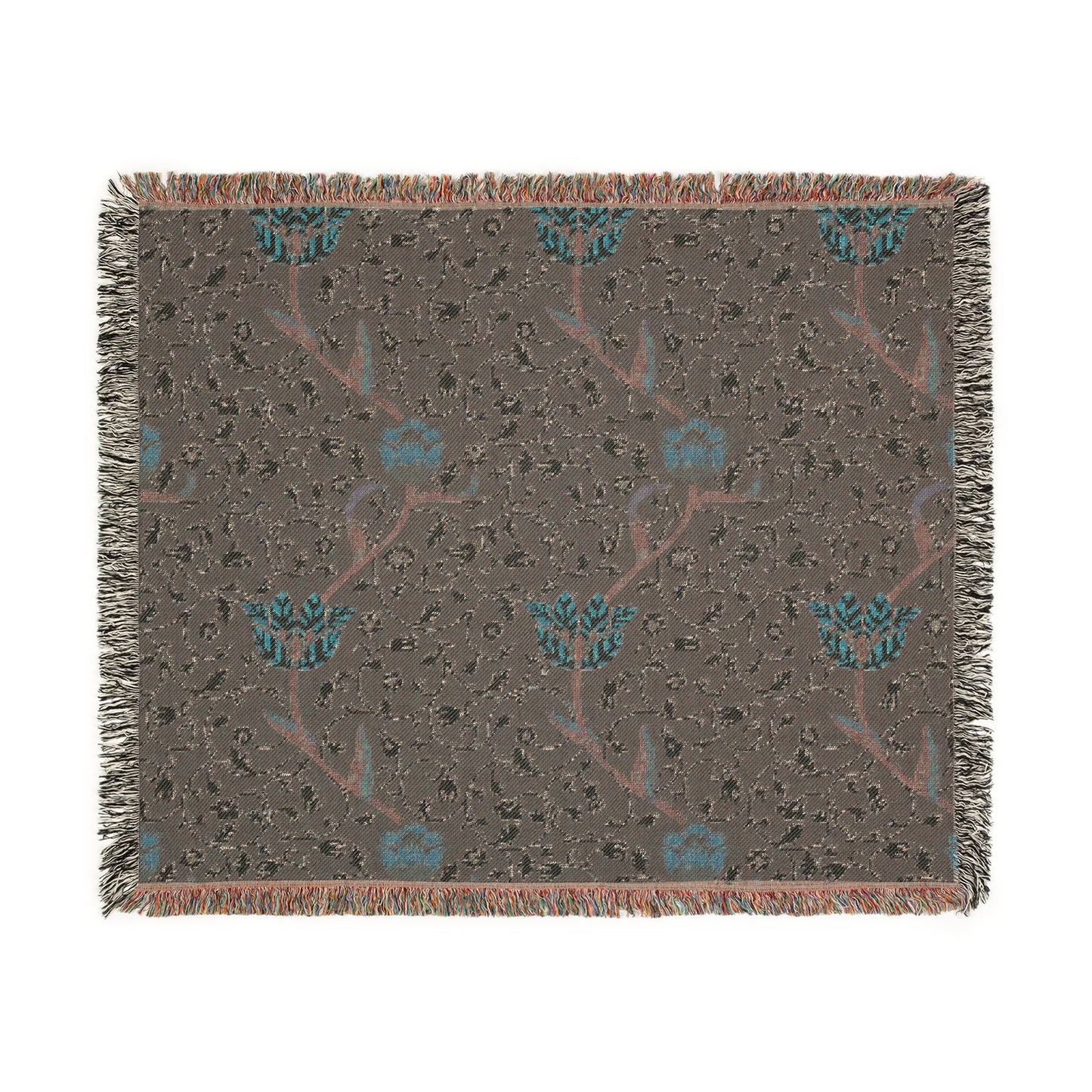 A woven cotton blanket with a geometric William Morris & Co pattern in blue, red and white colours, featuring fringed edges.