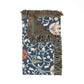 Decorative throw blanket with fringe on a floral patterned background
