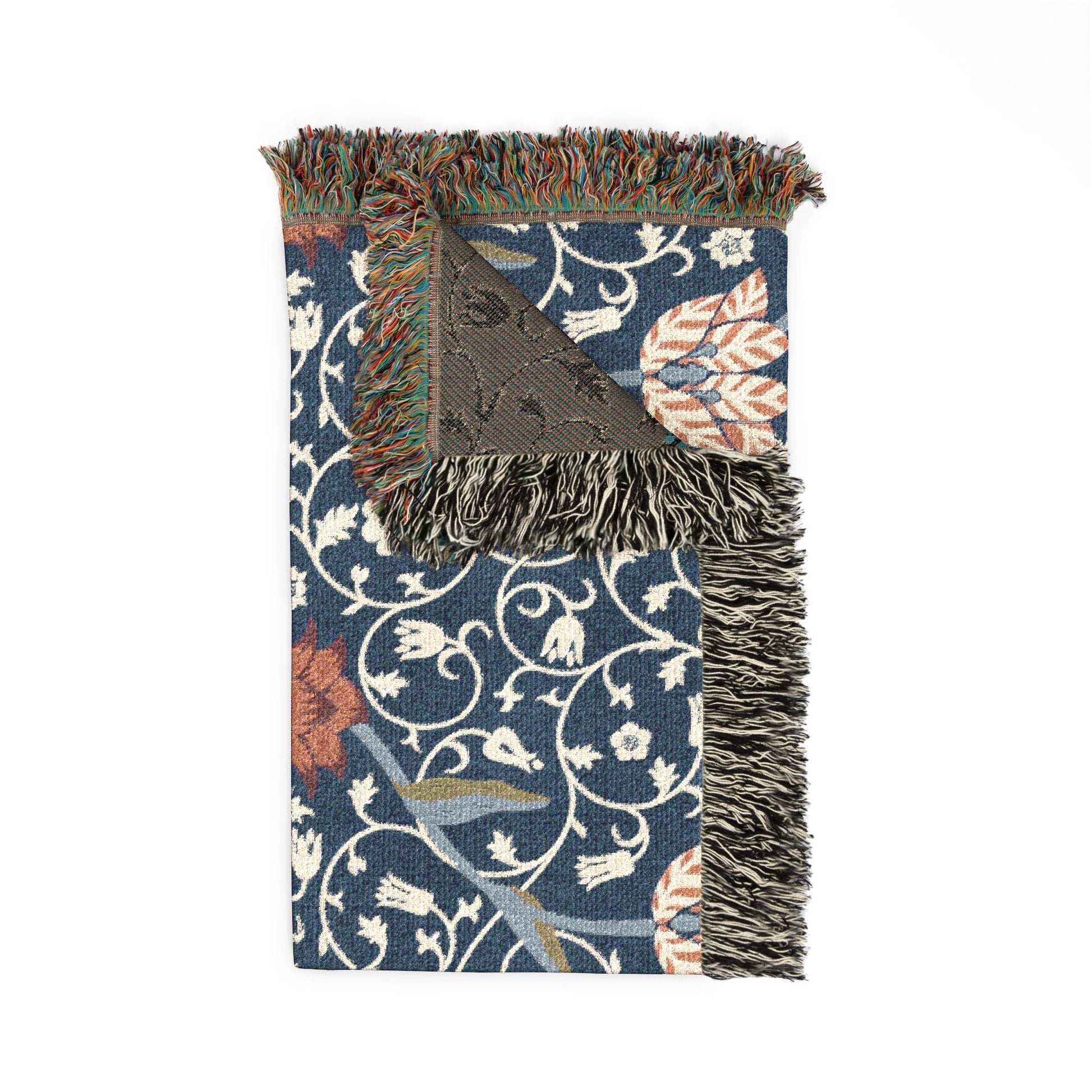 Decorative throw blanket with fringe on a floral patterned background