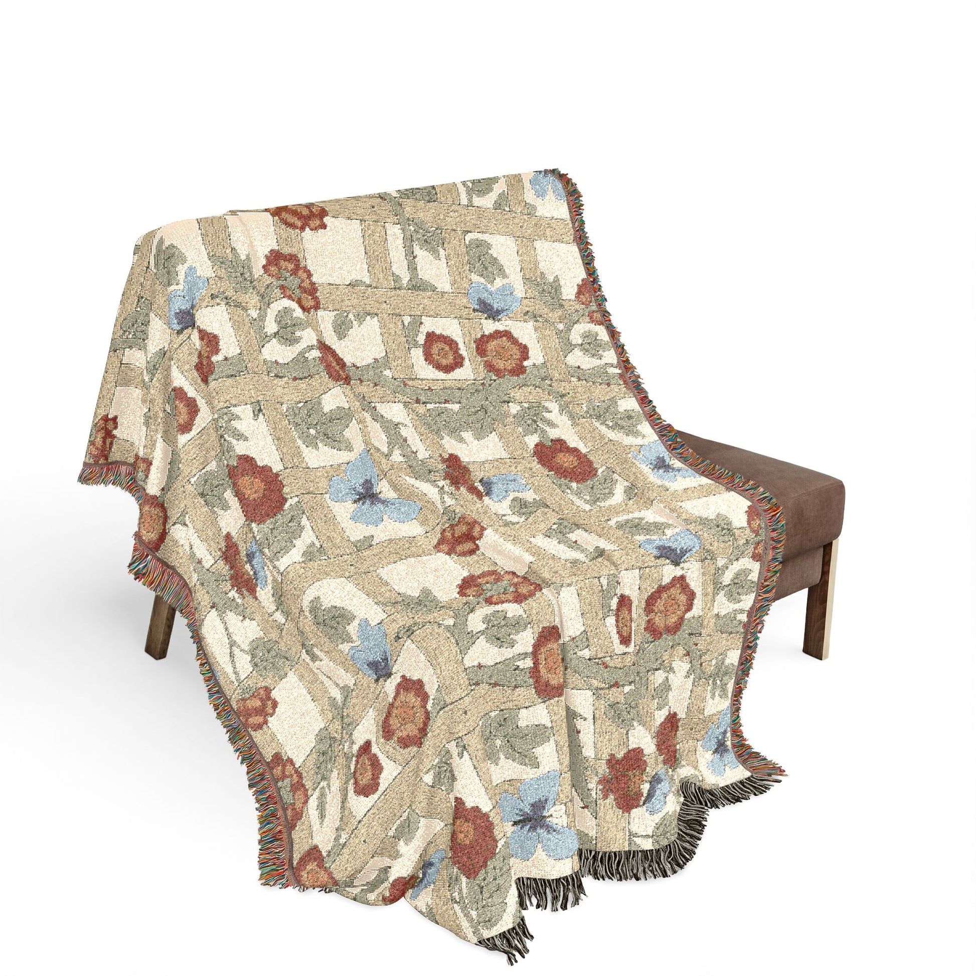 Floral patterned throw blanket draped over a chair on a white background