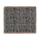 Woven blanket with a geometric pattern on a white background