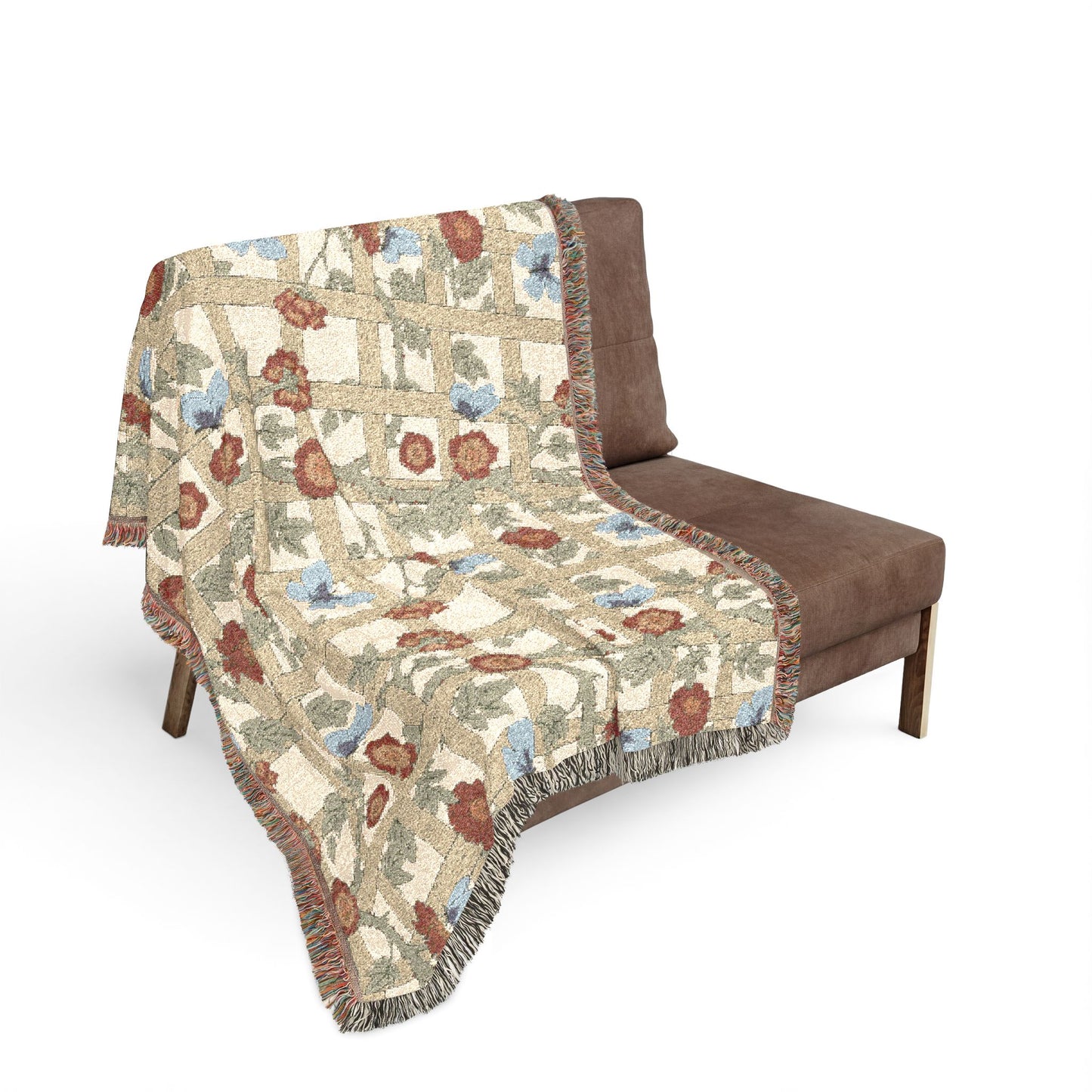 Floral patterned throw blanket draped over a brown chair on a white background