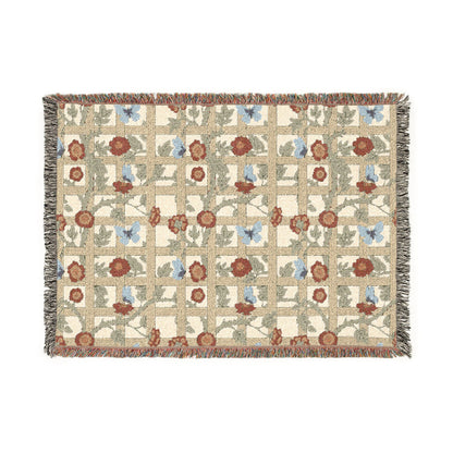 Floral and butterfly patterned throw blanket on a white background