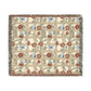 Floral and butterfly patterned throw blanket on a white background