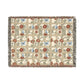 Woven blanket with floral and butterfly pattern on a white background