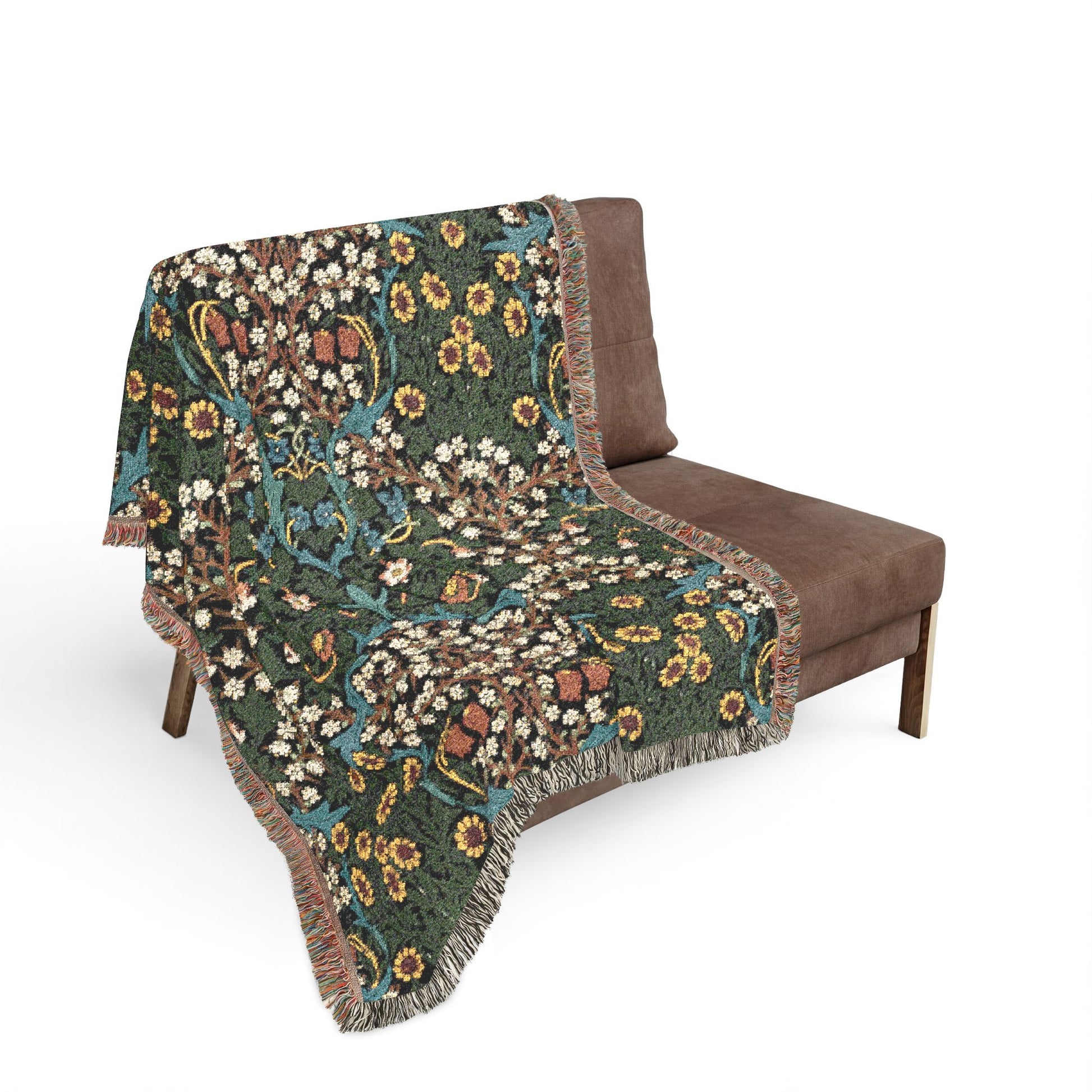 Floral patterned blanket draped over a brown chair on a white background