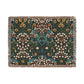 A woven cotton blanket with a floral pattern in multiple colors, including green, blue, and red, with fringed edges.