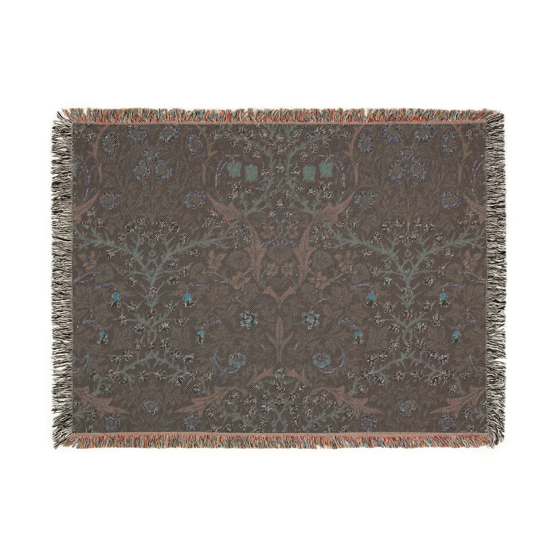 A woven cotton blanket with a floral William Morris & Co pattern in multiple colours, including green, blue, and red, with fringed edges.