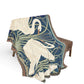 Decorative throw blanket with swan design on a chair