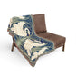 Decorative throw blanket with swan design draped over a brown chair on a white background