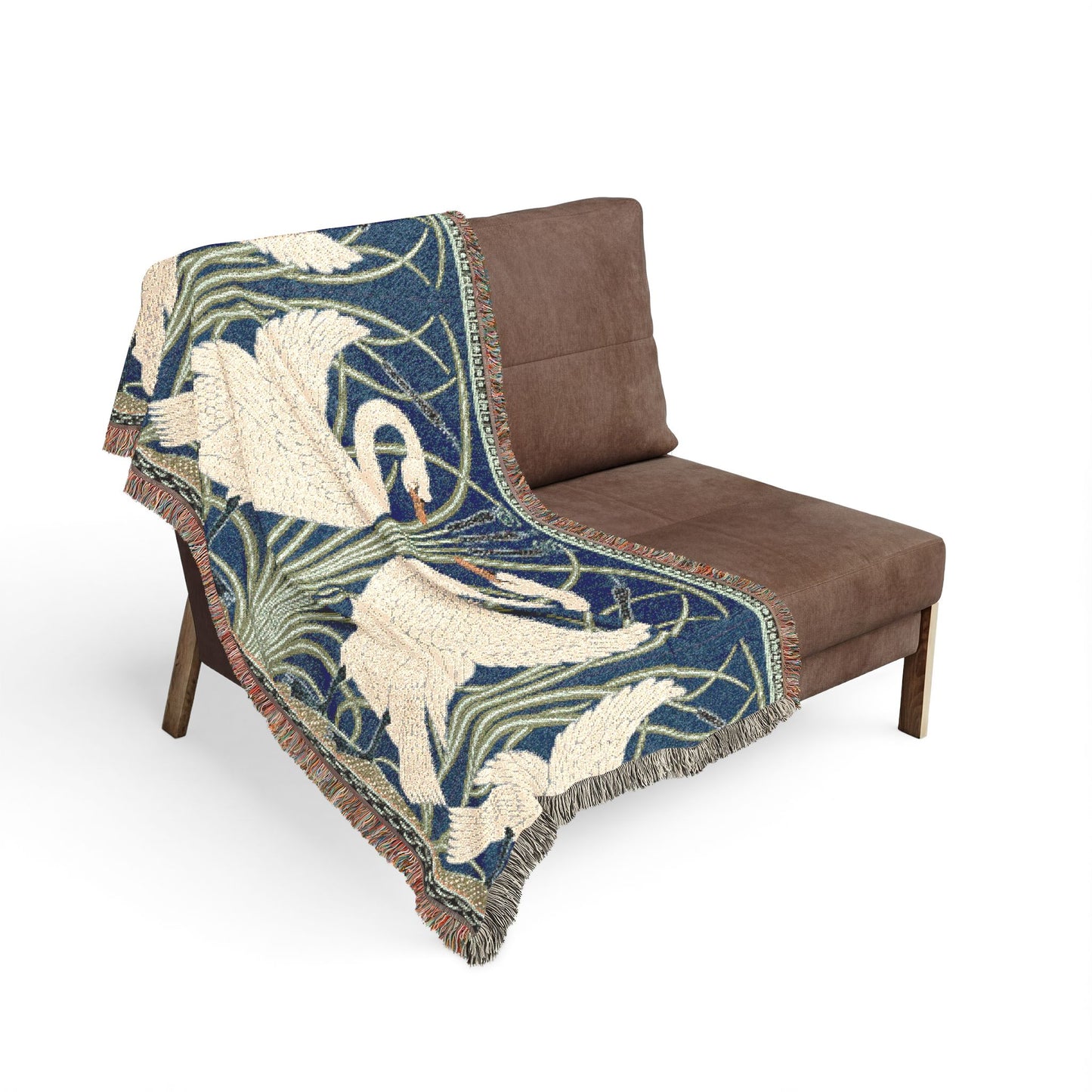Decorative throw blanket with swan design draped over a brown chair on a white background