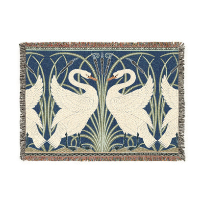 Woven blanket with swan design on a blue background