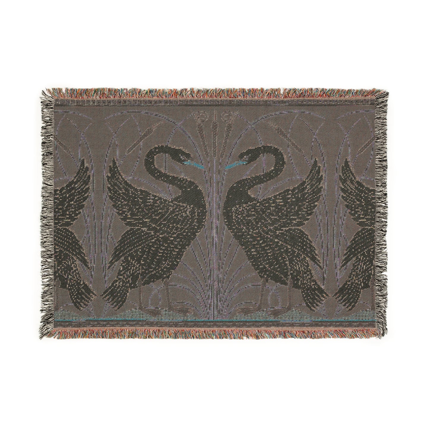 A woven cotton blanket with a geometric William Morris & Co pattern featuring swan motifs in a white and green colour scheme with colourful fringed edges.