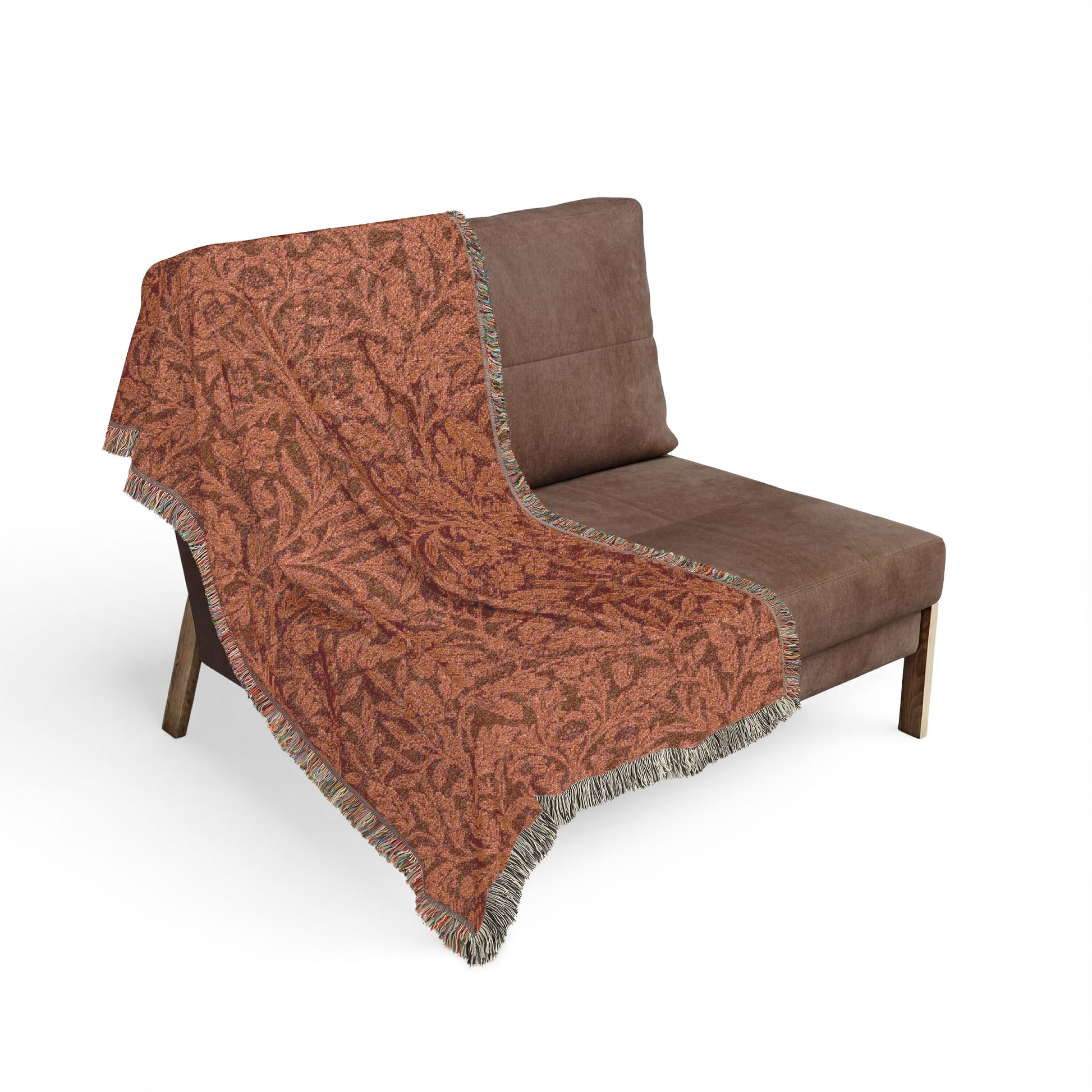 Brown patterned throw blanket draped over a brown chair on a white background