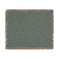 Textured green blanket with leaf pattern on a white background