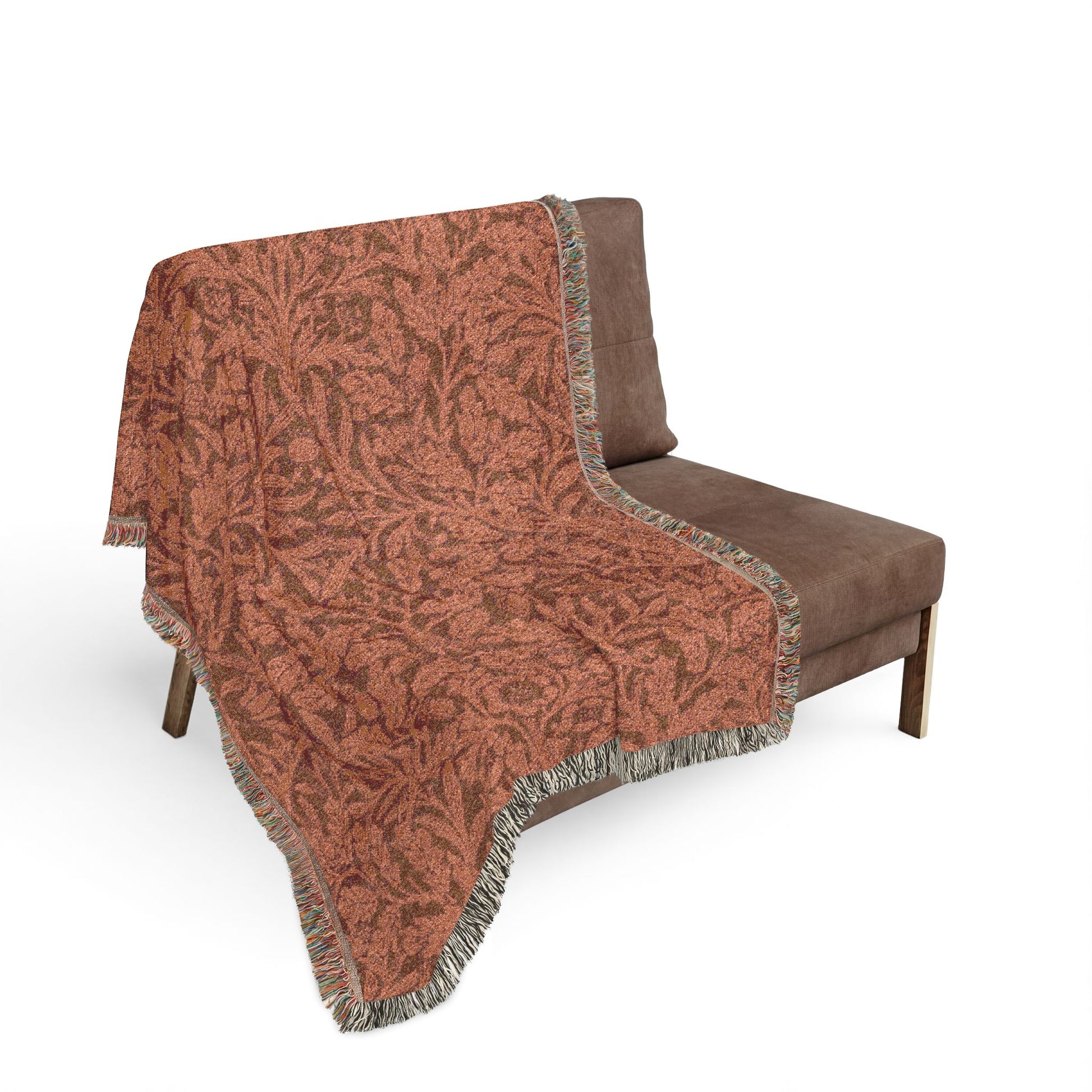 Brown patterned throw blanket draped over a brown chair on a white background