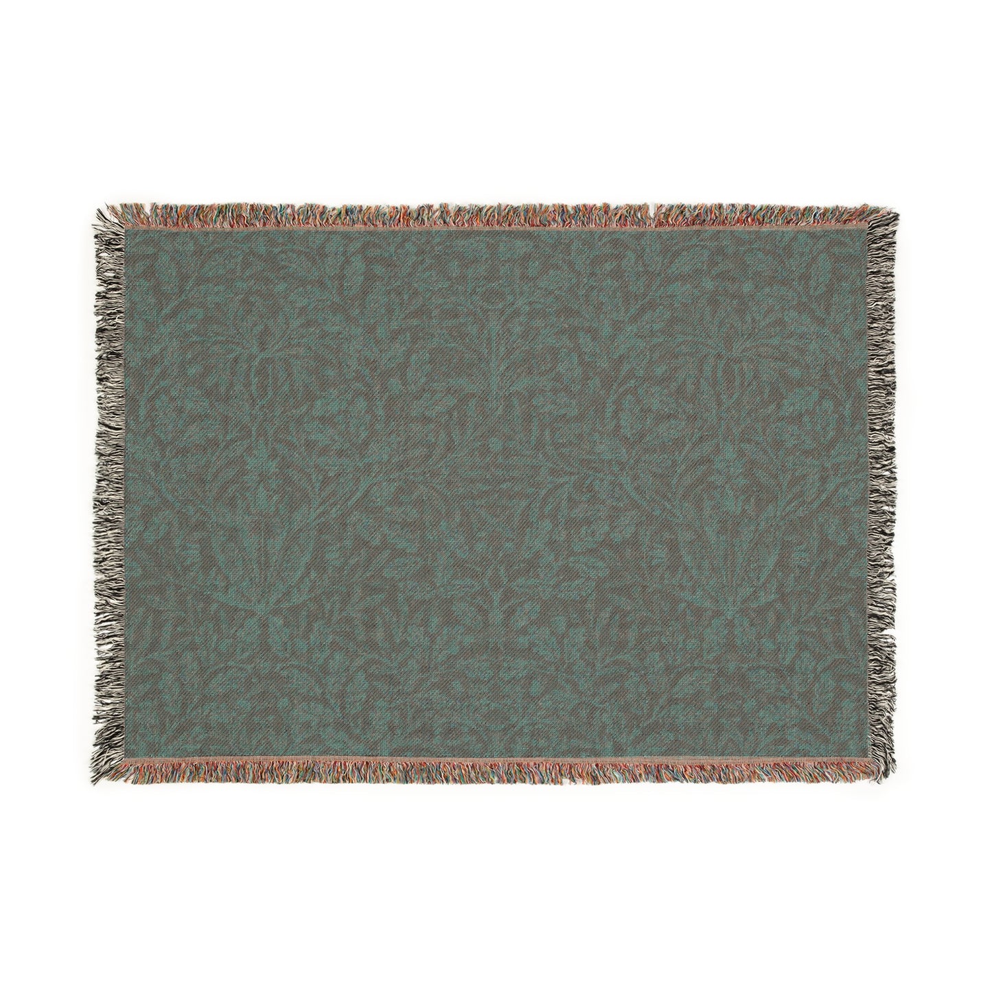 A woven cotton blanket with a floral William Morris & Co geometric pattern in a rust colour, featuring a colourful fringed edge.