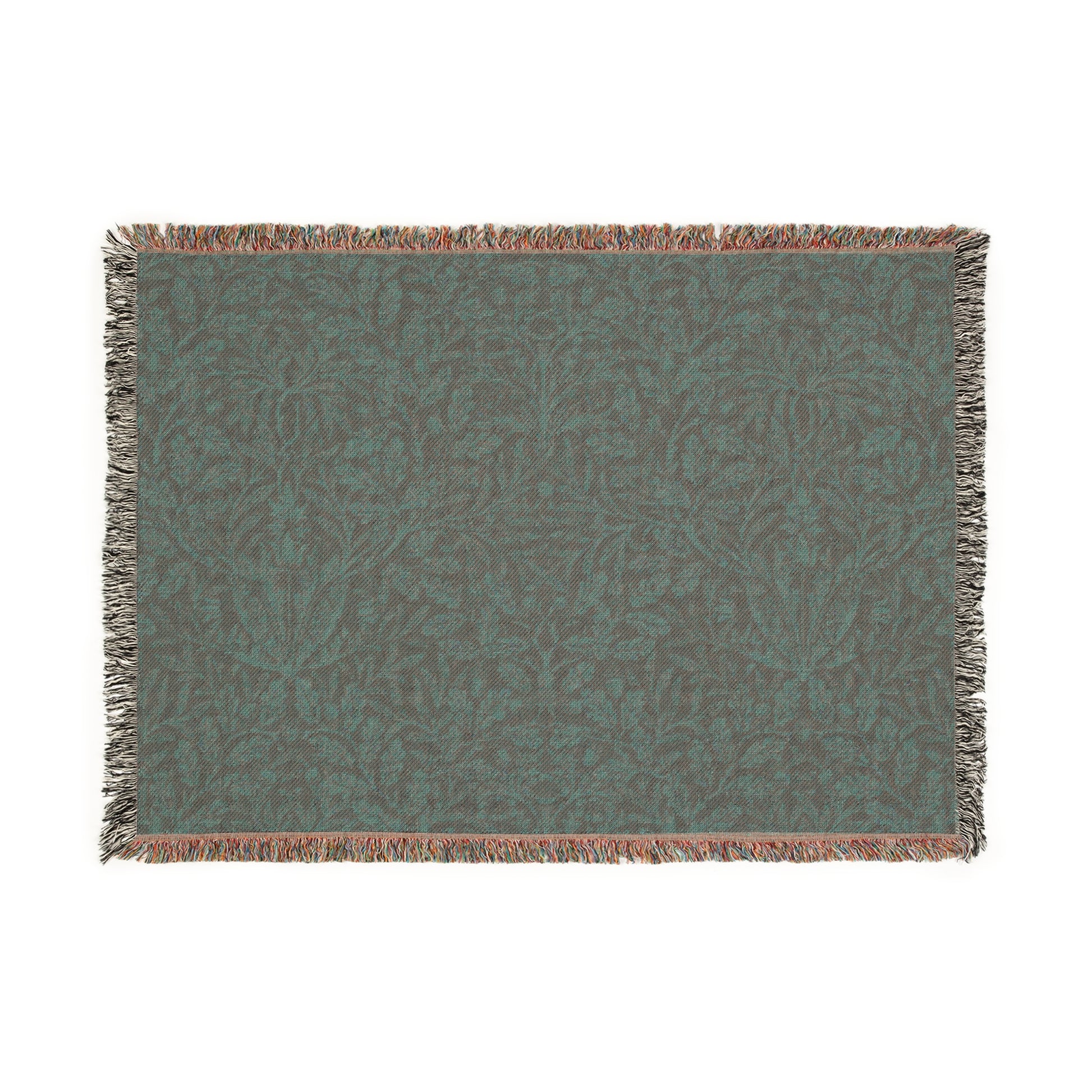 A woven cotton blanket with a floral William Morris & Co geometric pattern in a rust colour, featuring a colourful fringed edge.