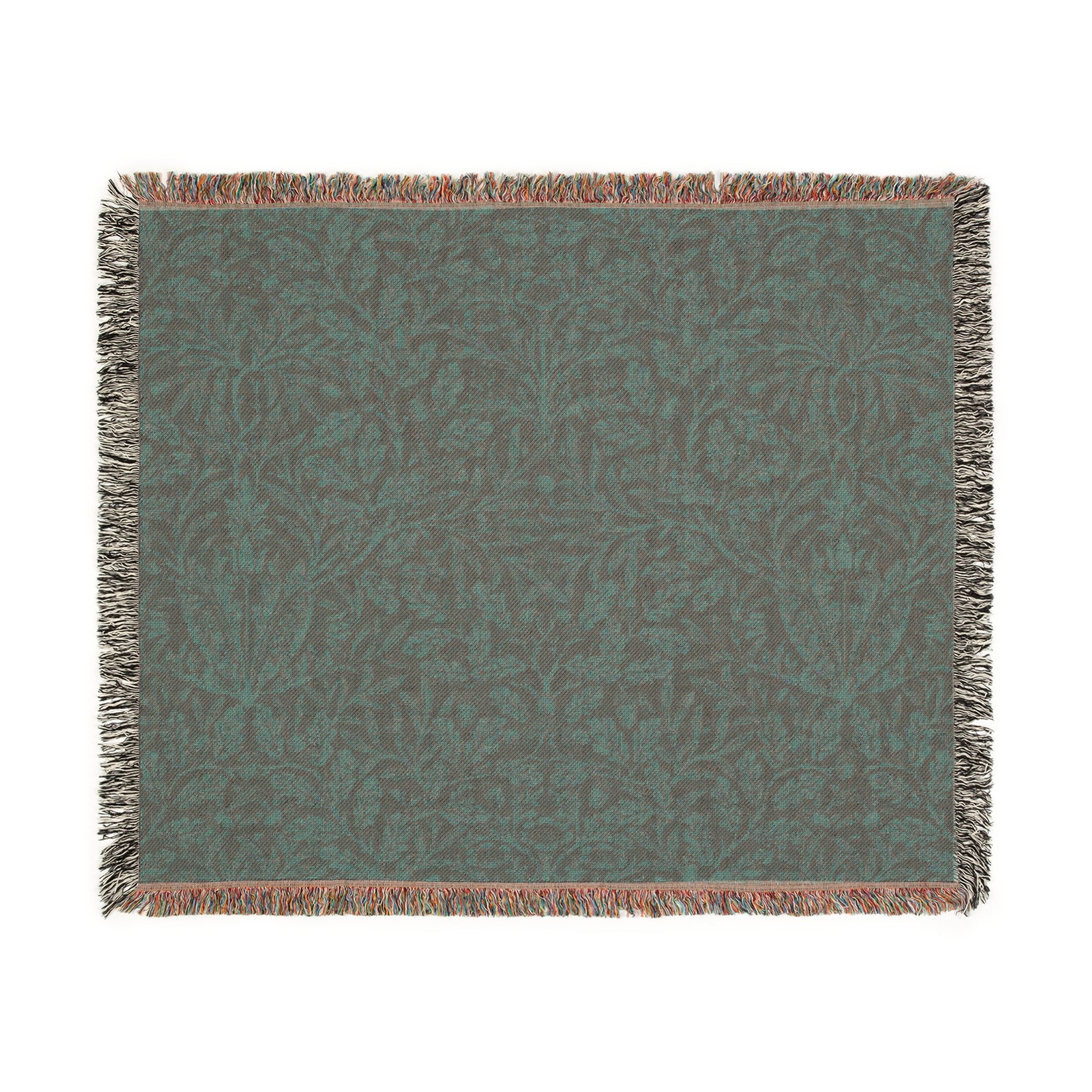 A woven cotton blanket with a floral William Morris & Co geometric pattern in a rust colour, featuring a colourful fringed edge.