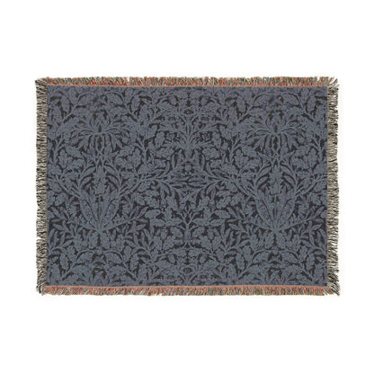 A woven cotton blanket with a geometric William Morris & Co pattern in smoky blue colour, featuring fringed edges.