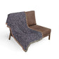 Brown chair with a patterned gray blanket draped over it on a white background