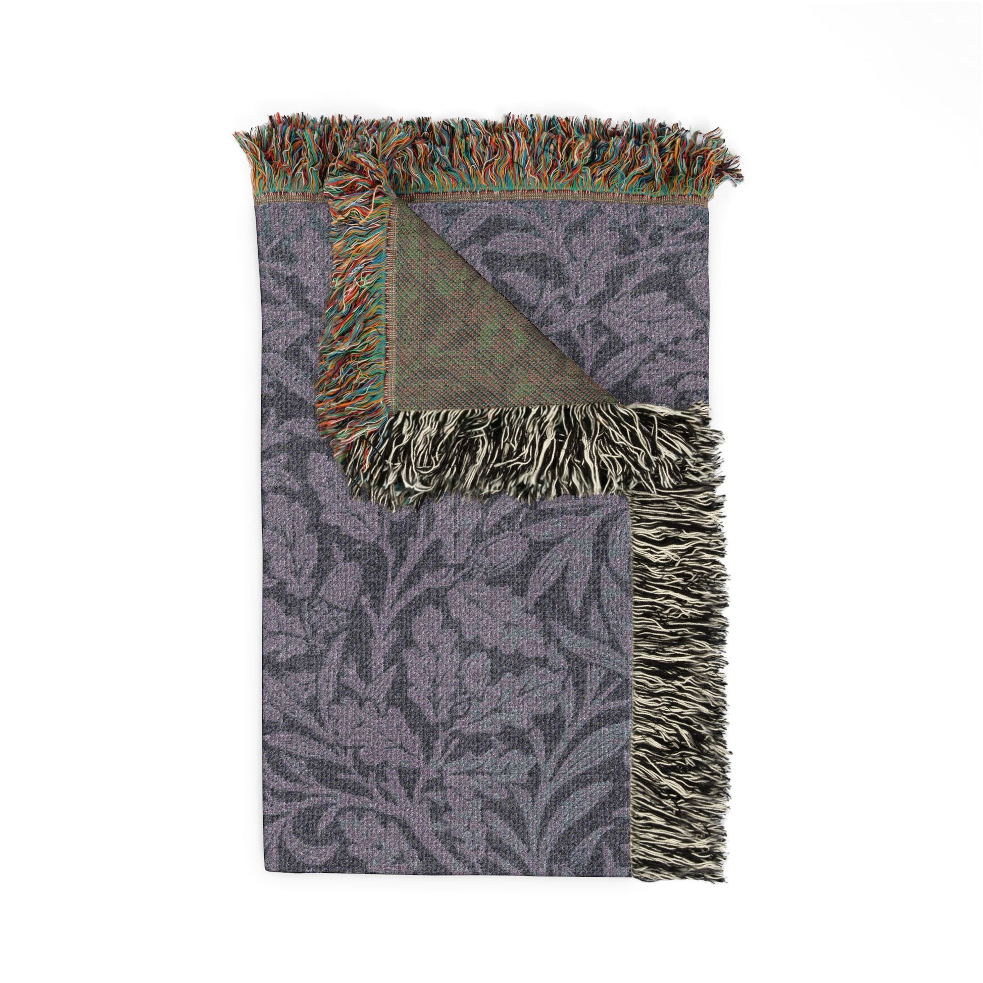 Floral patterned blanket with fringed edges on a white background
