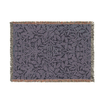 Floral patterned throw blanket with fringe on a white background